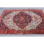 Antique Baktiari rug with a medallion and all-over stylised floral design on an ivory ground, with