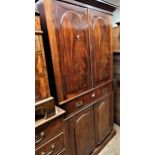 19th Century figured mahogany bookcase, the moulded cornice above a pair of arched figured panel