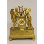 Early 19th Century French ormolu mantel clock, the circular enamel dial flanked by two figures of