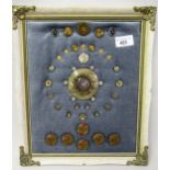 Small collection of various buttons mounted in a rectangular lacquered frame