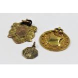 Two 9ct gold sporting medallions and a small St. Christopher, 12g