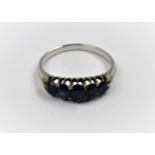 Unmarked white metal five stone sapphire set ring, size L
