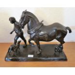 20th Century bronzed composition group of a figure leading a work horse, 18ins wide