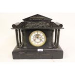 Late 19th century black slate two train manel clock, with visible escapement, together with a walnut