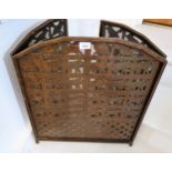 20th Century patinated iron fire screen with pierced decoration in the form of African animals,