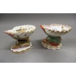 Pair of Berlin porcelain shell pattern pedestal salts, the bases in the form of sea serpents