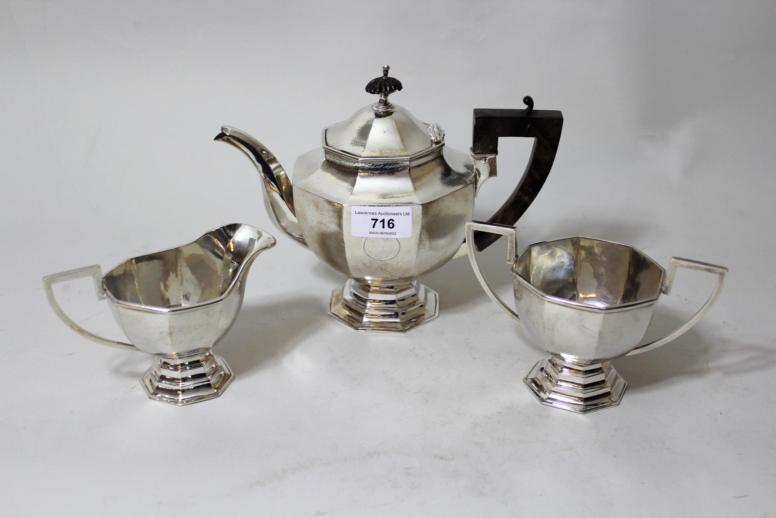 Chinese silver three piece tea service of European octagonal baluster pedestal design, marked '