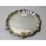 Small late Victorian silver salver in 18th Century style, the shaped moulded shell pattern rim on