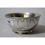 Small early 20th Century Japanese silver bowl relief decorated with bamboo on a hammered ground,