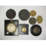 Six various bronze, brass and wooden medallions, together with a silvered lead medallion depicting