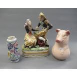 Hispania porcelain figural group, 14ins high, together with a French pottery pig form jug and