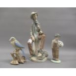 Lladro figure of a violinist sitting on a 48km milestone, Nao figure of a young boy with a
