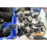 Two boxes containing a collection of various 20th Century cameras, including an Olympus SLR with