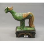 Chinese brown and green glazed pottery roof ridge tile in the form of a standing exotic bird on a