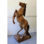 20th Century carved wooden figure of a rearing horse, 57ins high