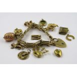9ct Gold gate link bracelet with five attached charms, the bagpipe charm in 18ct gold, together with