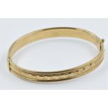 9ct Gold rigid bangle with cast decoration Weight - 12g In good condition. No damage or repair.