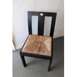 Arts & Crafts oak side chair with a plain splat back above a drop in rush seat, on plain rectangular