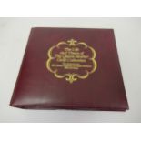 Album containing a collection of thirty five 22ct gold replica stamps, ' The Life and Times of the