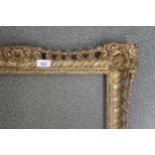 20th Century gilt composition picture frame, with open fretwork decoration, together with a gilt