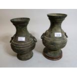 Pair of heavy Chinese patinated bronze baluster form vases with ring handles, 9.5ins high