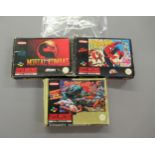 Three Super Nintendo entertainment system games, including Street Fighter 2, Mortal Kombat and