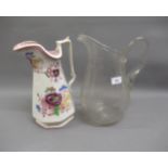 19th Century large glass jug and another pottery jug with floral decoration