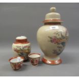 Pair of Japanese Kutani tea bowls, together with two Japanese satsuma jars with covers