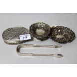 Two small silver trinket dishes, pair of silver sugar tongs and a Continental white metal oval