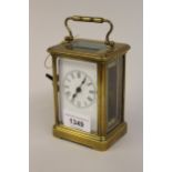 Small French gilt brass carriage clock with enamel dial