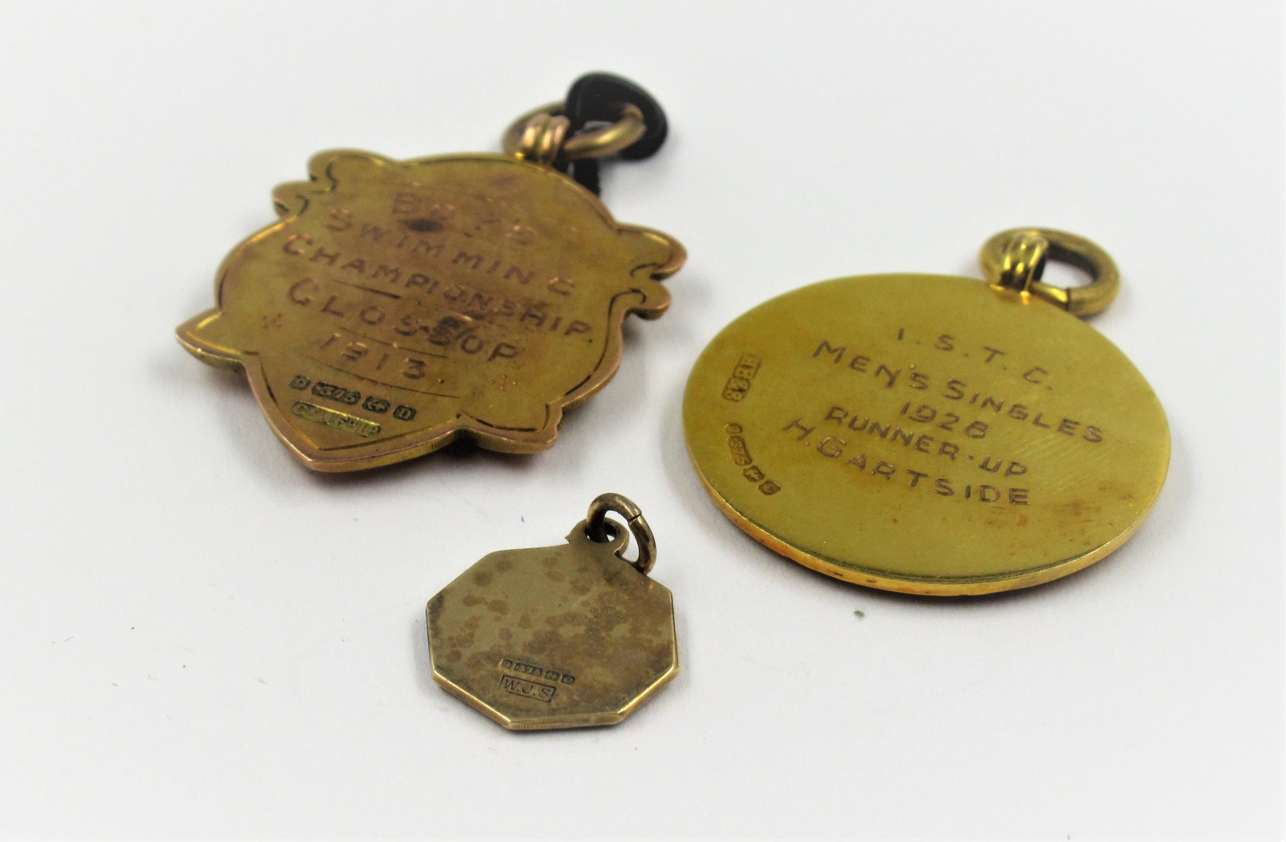 Two 9ct gold sporting medallions and a small St. Christopher, 12g - Image 2 of 2