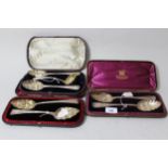 Two cased pairs of silver berry spoons, together with another cased pair of berry spoons with sifter