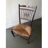 Early 20th Century beechwood nursing chair with a spindle back and newly rushed seat
