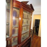 Edwardian mahogany and marquetry inlaid wall cabinet, the broken arch pediment above a glazed door