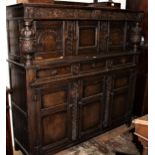 Mid 20th Century oak court cupboard, the top with three carved panelled doors flanked by turned