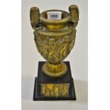 Cast bronze classical style two-handled urn, decorated with various figures on a black slate base