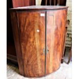 George III mahogany bow fronted two door hanging corner cabinet, 26ins wide