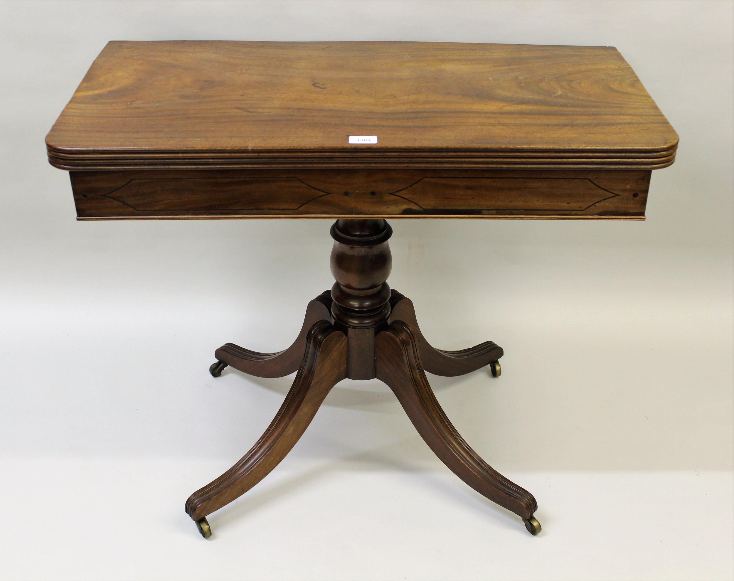 Regency mahogany fold-over card table on a turned column support with quadruped, 36ins wide