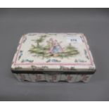 French faience rectangular box and cover, decorated with musicians in a landscape (at fault)