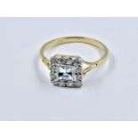 18ct Yellow gold ring set square cut aquamarine surrounded by diamonds, size N Good overall