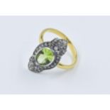 Yellow gold dress ring set with a central oval peridot surrounded by rose cut diamonds, unmarked,