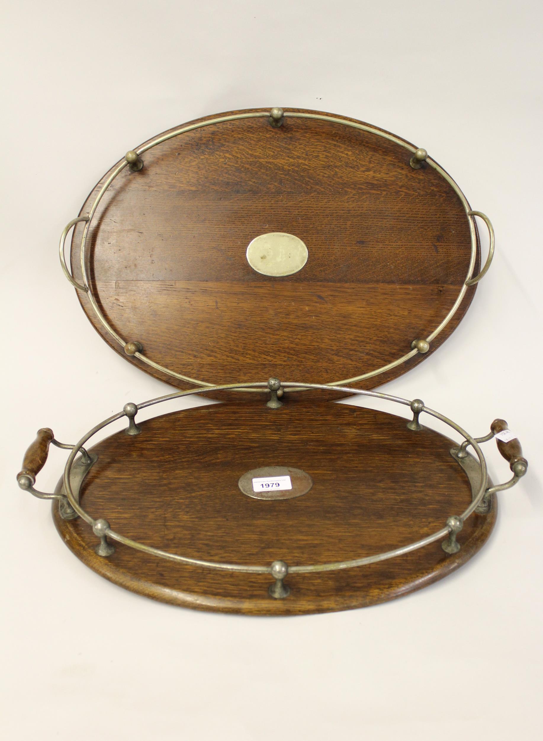 Two Edwardian oak and silver plate mounted drinks trays, the largest 20ins wide