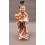 19th Century Chinese porcelain figure of a standing female deity holding a lotus vase, decorated