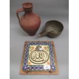 20th Century Persian style blue bordered tile on wooden backing board, small terracotta jar and an