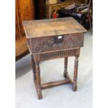 17th Century oak bible box, the hinged sloping plank top above a carved panel front, raised on a