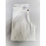 Chanel, pair of ladies white jeans, size 36 together with a Chanel navy blue skirt with buttons in