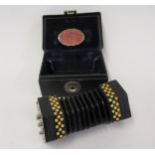 Rare Wheatstone miniature twelve button concertina with pierced nickel plated octagonal end caps,