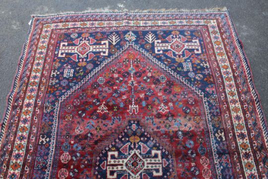 Large Shiraz rug with a medallion and all-over stylised design on a red ground with blue corner - Image 2 of 4