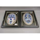 Pair of framed porcelain wall masks by Sargadelos, each mounted to a glass panel in a black