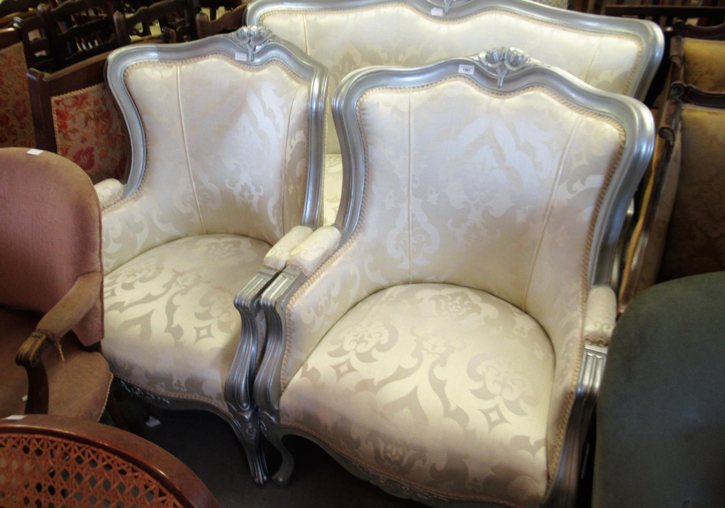 Reproduction French style three piece silvered and carved wooden salon suite upholstered in floral